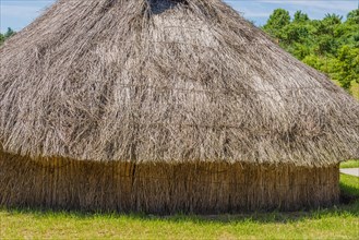 Buyeo, South Korea, July 7, 2018: Closeup of large straw thatch building in traditional Korean