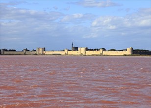 The medieval town of Aigues Mortes in the middle of the salt marshes, Gard, Petite Camargue,