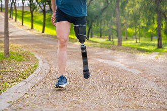 Cropped photo of an unrecognizable runner with prosthetic leg training in a park