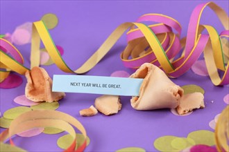 Optimistic Silvester New Year celebration concept with open fortune cookie and text 'Next year will