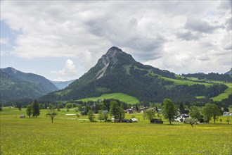 Summer austrian landscape with green meadows and impressive mountains, view from small alpine