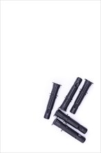 Black plastic dowels on white background, top view