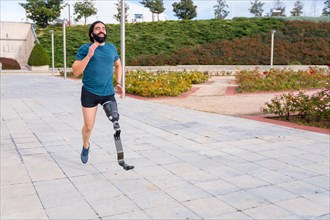 Physically disabled man with prosthetic leg running in an urban park