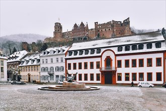 Heidelberg, Germany, February 2020: Town square called 'Karlsplatz' with snow in winter in historic