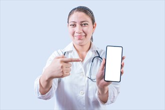 Female doctor showing and pointing an advertisement on the smartphone screen isolated. Smiling