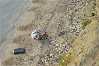 Picnic on the beach among washed up rubbish, Cape Rodon, Albania, Europe