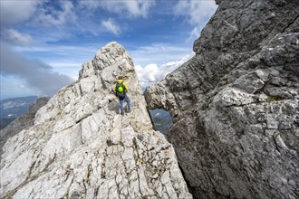Mountaineer on a narrow rocky ridge, Watzmann crossing to Watzmann Mittelspitze, view of mountain