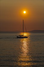 Sailing ship at sunrise in the bay of Gaia di Mola, off Porto Azzurro, Elba, Tuscan Archipelago,
