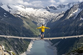 Mountaineers on a suspension bridge, picturesque mountain landscape near the Olpererhuette, view of