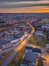 Aerial photo of a town at dusk with illuminated sky, Christmas tree on the roof, Black Forest,