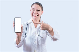 Young female doctor showing and pointing at smatphone screen isolated. Smiling female doctor