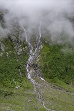 Mountain streams flowing over steep mountain slopes, cloudy mountain landscape, Furtschaglhaus,