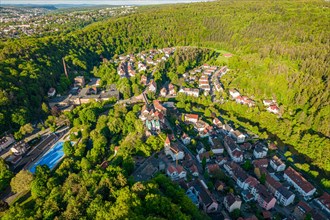 Aerial view of a town on the slope of a wooded hill with visible green areas, Pforzheim, Germany,