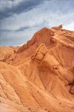 Eroded mountain landscape, sandstone cliffs, canyon with red and orange rock formations, Konorchek