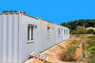 Portable corrugated metal storage buildings under clear blue sky