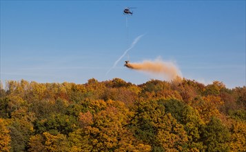 Helicopter fertilising over a wooded area, Osterholz, Wuppertal, North Rhine-Westphalia, Germany,
