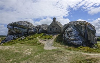 Former village of Meneham on the Atlantic coast with partly thatched houses between granite rocks,
