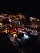 Night view of an illuminated road full of tractors and people, farmers protest, Black Forest, Bad