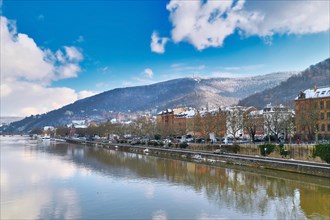 Heidelberg, Germany, February 2021: Neckar river with Odenwald forest hill with historical castle.
