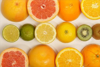 Photographic background of fruit cut in half with white background. orange, grapefruit, kiwi, lime,