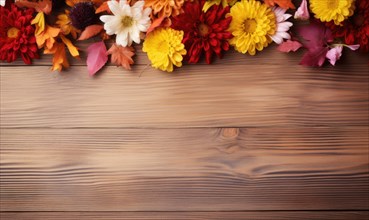 Fall leaves and flowers arranged on a rustic wooden background AI generated