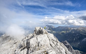 Mountaineer on the rocky summit of the Watzmann Mittelspitze, Watzmann crossing, view of mountain