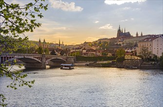 Boats on Vltava river and Hradcany castle in the background, in Prague, Czech Republic (Czechia),