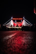 People in front of the illuminated 'Christmas Circus' tent at night, Reutlingen, Germany, Europe