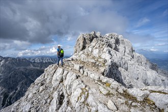 Mountaineer on a narrow rocky ridge, Watzmann crossing to the Watzmann Mittelspitze, Berchtesgaden