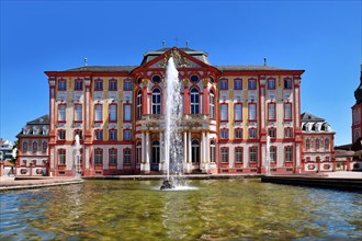Bruchsal, Germany, August 2023: Baroque castle called Bruchsal Palace with fountain on sunny day,