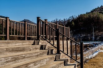 Wooden observation platform in wilderness park on sunny winter day