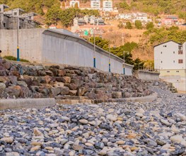 Landscape of Pebble Beach, South Korea with unfinished new construction in the left frame and white