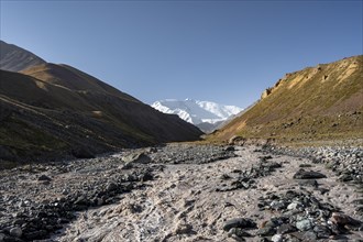 Achik Tash river, Achik Tash valley, behind glaciated and snow-covered mountain peak Pik Lenin,