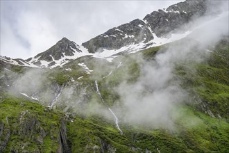 Cloudy mountains with steep green meadows, Berliner Hoehenweg, Zillertal, Tyrol, Austria, Europe