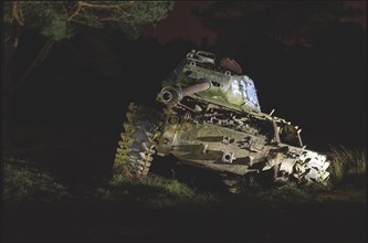 An old tank illuminated at night in the forest with dramatic light, M41 Bulldog, Lost Place,