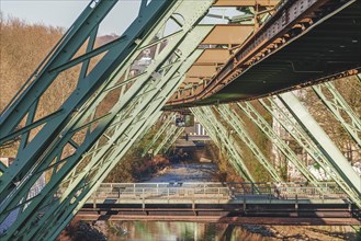 Steel bridge structure of a suspension railway over a river on a sunny day, Wuppertal Elberfeld,