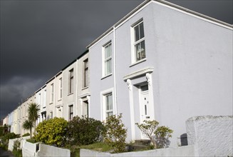 Terraced housing in Falmouth, Cornwall, England, UK with storm clouds overhead
