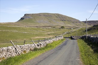 Road and dry stonewalls, Pen Y Ghent, Yorkshire Dales national park, England, UK