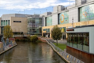 River Kennet flowing past The Oracle shopping centre in town centre, Reading, Berkshire, England,