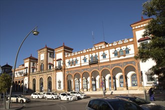 White taxis outside historic railway station building, Jerez de la Frontera, Spain, Europe