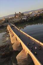 Roman bridge spanning river Rio Guadalquivir with Mezquita buildings, Cordoba, Spain, Europe