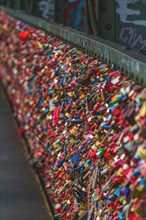 A multitude of colourful love locks attached to a bridge railing, Hohenzollern Bridge, Cologne