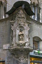 Veneration of the Virgin Mary with a canopy on a corner house in the historic centre, Genoa, Italy,