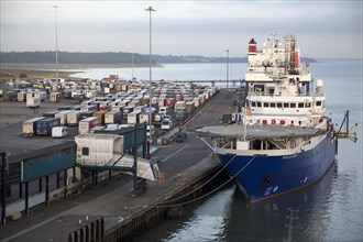Ships and parked HGVs on quayside at the port of Harwich, Essex, England, UK, foreground Horizon