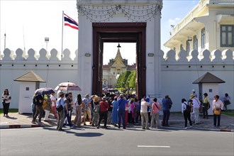 Crowds of tourists push through the entrance gate, Mani Nopparat Gate into the Grand Palace,