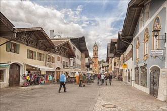 Obermarkt, shops, pedestrian zone, St Peter and Paul church at the back, Mittenwald, Bavaria