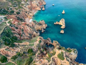 Aerial view of a rugged coastline with calm sea, Algarve, district Faro region in Portugal Lagos,