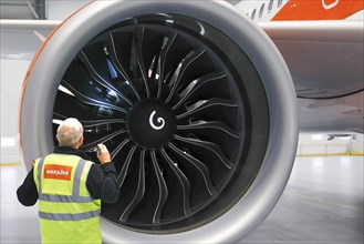 Olaf Gross, Licence Engineer at easyJet, checks the engine of an Airbus A320 Neo in front of the