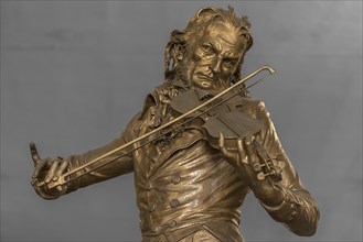 Detailed view of the bronze statue of the violinist Niccolo Paganini by the artist Niccolo