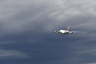 Emirates Airways Airbus A380-800 take-off in storm front with thundercloud, Munich Airport, Upper